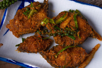 Stir fried catfish curry paste on wooden background