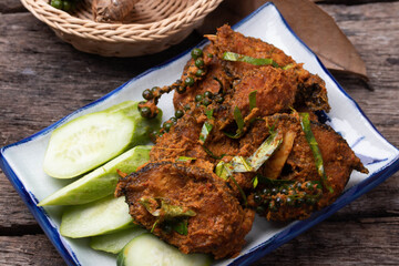 Stir fried catfish curry paste on wooden background