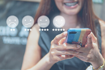 Customer Experience Concept  happy Business women holding the smartphone with a checked box on Excellent Smiley Face and Rating for a satisfaction survey