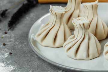 Caucasuan cuisine - Khinkali with meat on a white plate
