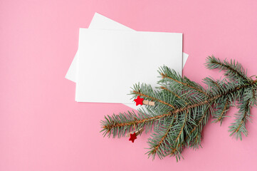 mock up blank white sheet, christmas fir tree on isolated pink background with place for text christmas new year theme
