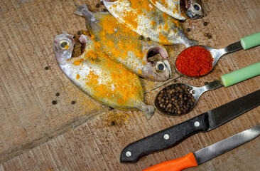 Fresh cleaned Japanese butterfish on wooden background.