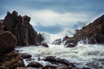 Big wave hitting the rocks on coastline in storm