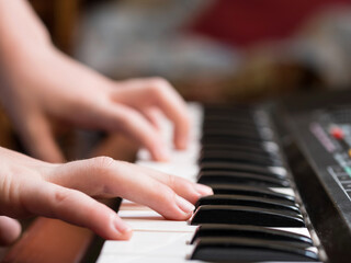 Fototapeta na wymiar a child's hand playing piano