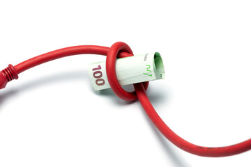 Red power plug and hundred euro banknote isolated on white. Expensive energy and cost of electricity concept.