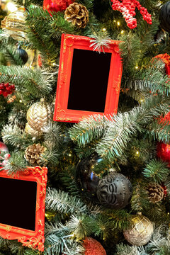 Red vintage photo frames hanging up on christmas tree close up