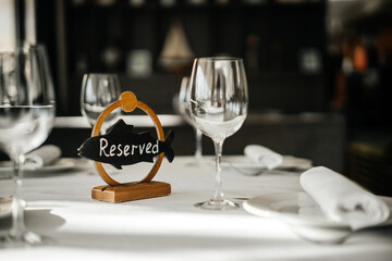 The inscription is reserved on the table with glasses in the restaurant. Free seats on holidays and weekends.
