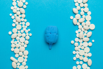 Human brain and pills on blue background. Neurological diseases and surgical treatment. Intelligence and psychological therapy.