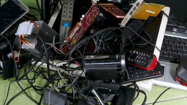 Pile of assorted electronic e-waste products, no visible logos, slider motion