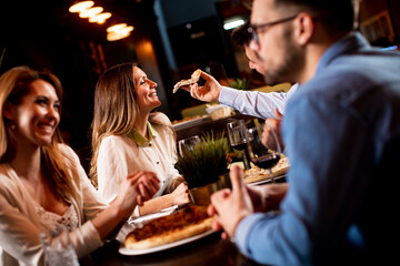 Young people having dinner in the restaurant