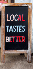 Free standing LOCAL TASTES BETTER sign. 