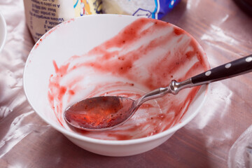 White empty jam bowl and metal spoon.