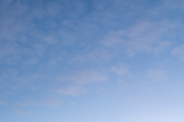 Gradient blue sky with plenty of small soft clouds. Tranquillity scene. Background image.