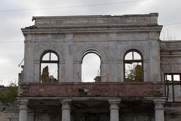 A ruined historic building against a gloomy sky.