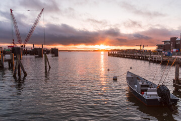 Fototapeta na wymiar Majestic sunset over a harbour and a ferry terminal. Falmouth, Cape Cod, MA, USA.