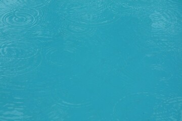 Swimming pool with water drops and reflection in the water in rainy day. Sport and background concept.