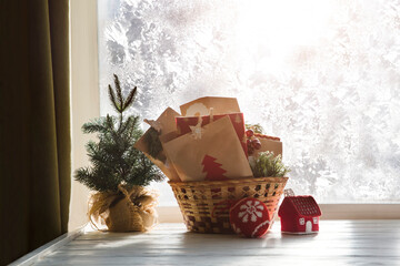 Handmade gift paper box advent calendar in basket for children against the background of a window...