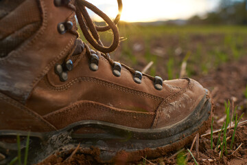 Detail of a mountain boot in a sunny day of trekking in the countryside