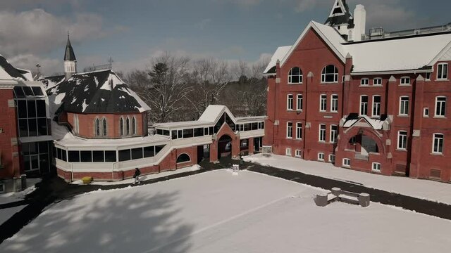 Bishop's University With Snow In Foreground During Winter In Lennoxville, Sherbrooke, Quebec, Canada. - aerial