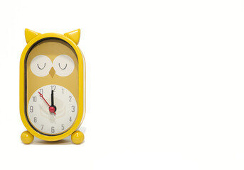 Yellow owl-shaped alarm clock alarm clock on white background.copy space