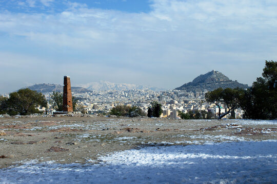 View of winter Athens covered by snow from the Phylopappou hill