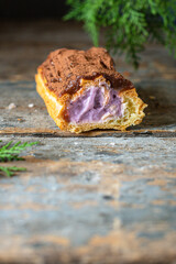 eclairs chocolate-covered in chocolate berry cut cream profiteroles ready to eat on the table healthy meal snack ingredient top view copy space for text food background rustic