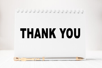 Notepad with inscriptions THANK YOU on a white background. business concept.