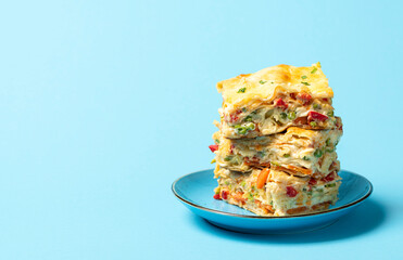 Vegetable lasagna, a big portion on a blue plate. Vegetarian food, homemade