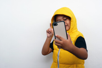 A little boy expression wearing a yellow jacket isolated on white background.