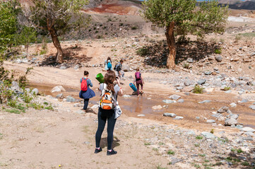 Group of Tourists Wash in Mountain River. Summer Landscape. Travel location of popular attraction. View of beautiful nature.