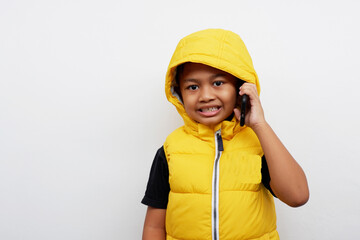 A little boy expression wearing a yellow jacket isolated on white background.