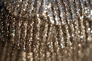 Close-up of beautiful beige Christmas ball as glittering background. Selective focus , blurred photo. 