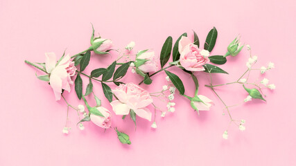 Creative layout made with pink and violet flowers on pink background. Flat lay.