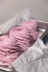 Pink strawberry homemade zephyr or marshmallow in a rectangular oleum plate. side view, close-up, selective focus.