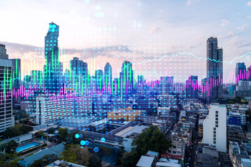 Market behavior graph hologram, sunset panoramic city view of Bangkok, popular location to achieve financial degree in Asia. The concept of financial data analysis. Double exposure.