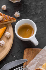 white cup of espresso coffee on dark background