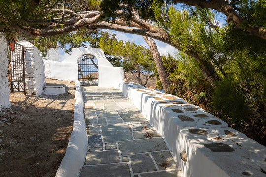 Cast iron gate in a white wall, Ios Island, Greece.