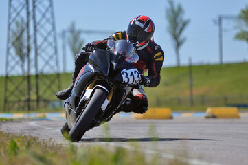 Motorcycle practice leaning into a fast corner on track