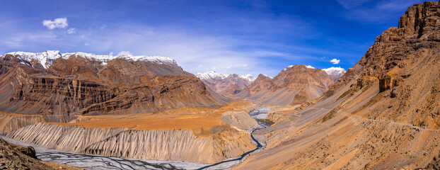 Serene Landscape of Spiti river valley with gully eroded and pinnacle geological weathered landform in cold desert arid region of Trans Himalayas Lahaul and Spiti district of Himachal Pradesh, India.