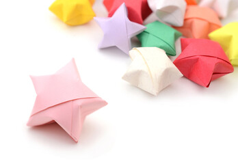 Pink lucky origami star with origami starson white