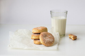 Milk and cookie. homemade shortcake and a glass of milk on the table on a white background
