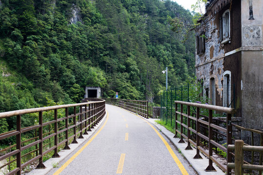 Ponteba Italy July 24th 2018. Ciclovia Alpe Adria on a former rail way. Old train tunnel in background. Radweg in Italy.