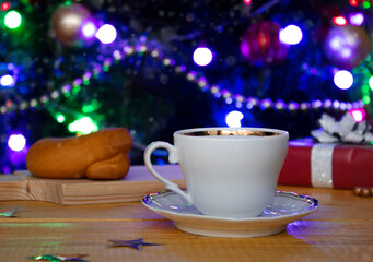 Christmas holiday mugs on wooden table over Christmas tree bokeh background