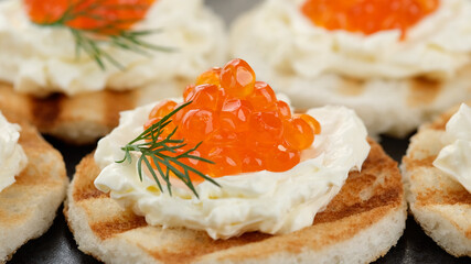 red caviar sandwiches with soft cheese close up