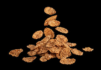 Falling bran flakes on black stone background