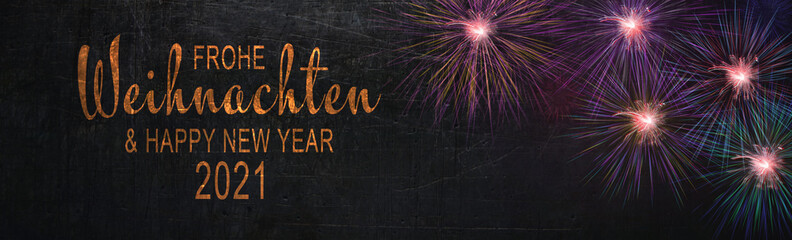 Fototapeta premium Colorful fireworks in front of rustic black stone texture - Christmas New Year background - Merry Christmas and Happy New Year 2021 