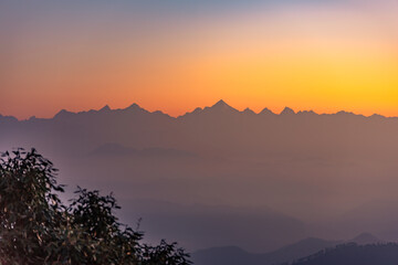 Mountain silhouette of Himalayas mountains during morning sunrise from Binsar, Kumaon region, Uttarakhand, India.
