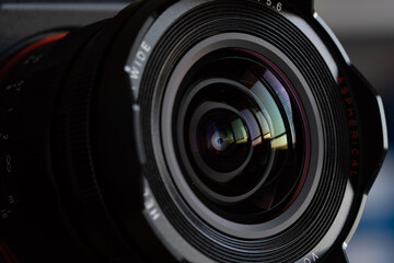 Fototapeta na wymiar Close-up camera lens with color reflections