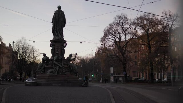 Morning Traffic At Sunset In Munich City Lehel Germany. Cars Are Driving By Maxmonument Munich Germany - Slow Motion