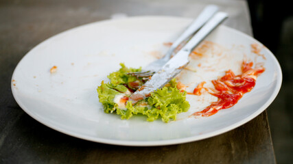 vegetable leftovers on a plate with a fork and knife